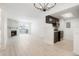 Open living space with fireplace, balcony, and modern kitchen featuring dark cabinets at 1842 S Pitkin Cir # A, Aurora, CO 80017