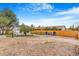 The backyard features gravel landscaping, and a wooden fence that enhances its charm at 3452 S Clay St, Englewood, CO 80110