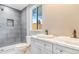 Modern bathroom featuring double sinks, shower with a shelf and contemporary finishes at 3452 S Clay St, Englewood, CO 80110