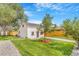 Charming home boasts a well-manicured lawn, and a beautiful tree that enhances its curb appeal at 3452 S Clay St, Englewood, CO 80110