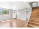 Bright living room with a staircase, wood floors and plenty of natural light at 3452 S Clay St, Englewood, CO 80110