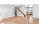 An open living room shows the hardwood floors and staircase at 3452 S Clay St, Englewood, CO 80110