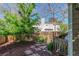 Charming backyard with stone pathway, wooden fence, and lush landscaping offering a peaceful retreat at 2364 S Harlan St, Lakewood, CO 80227