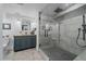 Modern bathroom features a vanity and large glass shower with black and gray tiling at 2364 S Harlan St, Lakewood, CO 80227