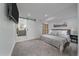 Comfortable bedroom featuring carpet, ensuite bathroom with sliding barn door, and TV at 2364 S Harlan St, Lakewood, CO 80227
