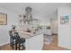 Stylish kitchen with stainless steel hood, granite countertops and white cabinetry at 2364 S Harlan St, Lakewood, CO 80227
