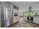 Spacious kitchen features stainless appliances, granite countertops, and an open layout to the dining room at 2364 S Harlan St, Lakewood, CO 80227