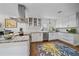 Bright kitchen features white cabinets, stainless appliances, granite counters, and a colorful area rug at 2364 S Harlan St, Lakewood, CO 80227