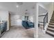 Basement lounge area with cozy blue sectional sofa, projector, and a sleek marble countertop bar area at 2364 S Harlan St, Lakewood, CO 80227