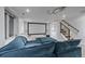 Basement Gathering room boasts large screen, comfy seating, projector and staircase at 2364 S Harlan St, Lakewood, CO 80227