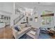 Bright living room with modern staircase, high ceilings, and a large window at 2364 S Harlan St, Lakewood, CO 80227