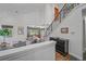Open-concept living room featuring modern railing, light colors and hardwood floors at 2364 S Harlan St, Lakewood, CO 80227