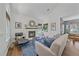 Cozy living room featuring a fireplace, hardwood floors, and ample natural light at 2364 S Harlan St, Lakewood, CO 80227