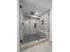 Glass shower stall with gray and black tile, and a built-in bench and showerhead at 2364 S Harlan St, Lakewood, CO 80227