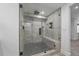 Large glass shower with gray tiled walls and ceiling-mounted shower head at 2364 S Harlan St, Lakewood, CO 80227