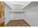 A functional walk-in closet with carpet flooring, clothes rods, and ample storage space at 2364 S Harlan St, Lakewood, CO 80227