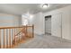 Upper level hall with staircase, closet, and a bright, open feel at 559 S Mobile Pl, Aurora, CO 80017