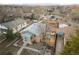 A home's aerial view, showcasing it's backyard, fence, driveway, and surrounding homes in the area at 1047 Meade St, Denver, CO 80204