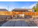 Outdoor patio with seating, a wooden fence, and string lights for ambiance at 1047 Meade St, Denver, CO 80204