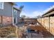 A spacious backyard with a patio seating area, fence, and access to the main house at 1047 Meade St, Denver, CO 80204