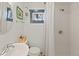 Bright bathroom features a shower, vanity, toilet and window, creating a serene and functional space at 1047 Meade St, Denver, CO 80204