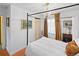 Bedroom featuring a four-poster bed, chandelier, and large windows creating a cozy and inviting space at 1047 Meade St, Denver, CO 80204