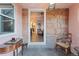 Entryway with stone walls, a chair, a small table, and a view into the living room with hardwood floors at 1047 Meade St, Denver, CO 80204