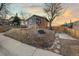 Charming exterior showcasing a two-story house with a unique stone front, landscaped yard, and tree at 1047 Meade St, Denver, CO 80204