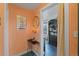 Hallway featuring a table, mirror, wall art, and doorway to an office, showing unique architectural details at 1047 Meade St, Denver, CO 80204