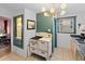 Kitchen boasts an vintage oven, modern light fixture, stainless steel appliances, and beautiful green accent wall at 1047 Meade St, Denver, CO 80204