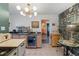 Kitchen featuring tile floors, modern lighting, stainless-steel mini fridge, wooden cabinets, and unique wallpaper accent at 1047 Meade St, Denver, CO 80204