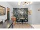 The kitchen features tile floor, modern lighting, island, and custom wallpaper detail with a unique dining table at 1047 Meade St, Denver, CO 80204