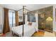 Elegant main bedroom with a four-poster bed, chandelier, and stylish wallpaper offering a luxurious retreat at 1047 Meade St, Denver, CO 80204
