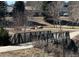 Metal bridge in the park providing pedestrian access to recreational areas and trails at 1047 Meade St, Denver, CO 80204