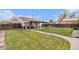 Spacious backyard features a large lawn, covered patio, and mature landscaping, perfect for outdoor living at 1293 S Perry St, Denver, CO 80219