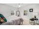 Comfortable bedroom with natural light, two windows, and minimalist decor at 1293 S Perry St, Denver, CO 80219