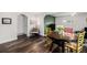 Bright dining area featuring hardwood floors, colorful chairs, and stylish decor accents with decorative green wall at 1293 S Perry St, Denver, CO 80219