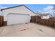 Detached two-car garage with additional storage space, and long driveway at 1293 S Perry St, Denver, CO 80219