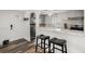 Modern kitchen with breakfast bar, stainless steel appliances, and updated countertops at 1293 S Perry St, Denver, CO 80219