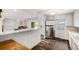 Open concept kitchen featuring a breakfast bar and stainless steel appliances at 1293 S Perry St, Denver, CO 80219
