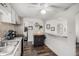 Bright kitchen featuring a breakfast bar, modern appliances, and stylish countertops at 1293 S Perry St, Denver, CO 80219