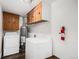 Functional laundry room with washer, dryer, and storage cabinets at 1293 S Perry St, Denver, CO 80219