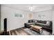 Comfortable living room featuring a sectional sofa, ceiling fan, and hardwood floors at 1293 S Perry St, Denver, CO 80219