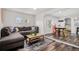 Cozy living room with a comfortable sectional sofa, stylish coffee table, and hardwood floors at 1293 S Perry St, Denver, CO 80219