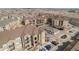 Serene aerial view of the complex showing a variety of apartment building, covered parking, and car parking at 17297 Wilde Ave # 205, Parker, CO 80134