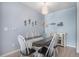 Dining room featuring modern decor, light blue accent wall and contemporary lighting at 17297 Wilde Ave # 205, Parker, CO 80134