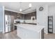 Modern kitchen with stainless steel appliances, dark cabinets, and a large island with a white countertop at 17297 Wilde Ave # 205, Parker, CO 80134