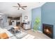 Inviting living room featuring a fireplace, ceiling fan, and view of the open kitchen at 17297 Wilde Ave # 205, Parker, CO 80134