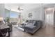 Open-concept living room featuring a large window, a ceiling fan, and modern decor at 17297 Wilde Ave # 205, Parker, CO 80134