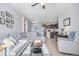 Spacious living room that opens to the kitchen and dining area, with natural light at 17297 Wilde Ave # 205, Parker, CO 80134